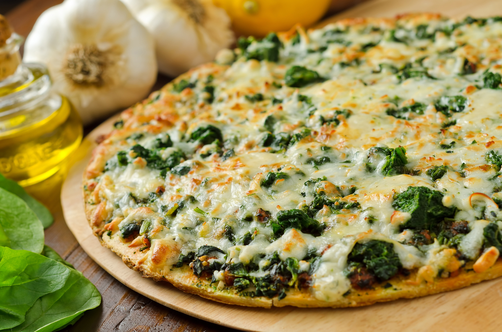 delicious thin crust pizza covered in spinach, mozzarella cheese and cooked to perfection.